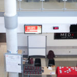 MED X Hamilton conference photo including two booths